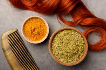 Flat lay composition with henna and turmeric powder on light grey table. Natural hair coloring