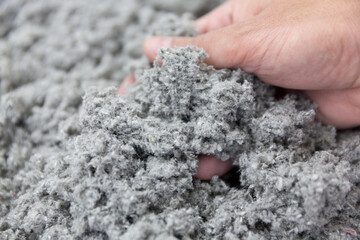 Hand Grasping Sustainable Cellulose Insulation