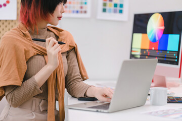 Portrait of female interior designer in office.