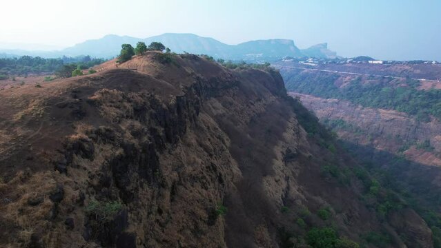 Aerial footage of a scene at the edge of a mountain at Kune village near Khandala India.