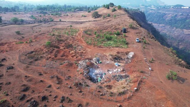Aerial footage of a scene at the edge of a mountain at Kune village near Khandala India.
