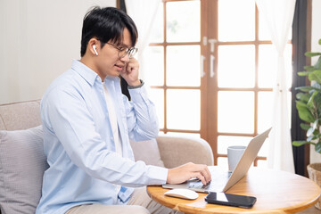 Online training. Young guy learns online by video conference in zoom app. On the screen, the teacher tells the information to him and other participants in the conference