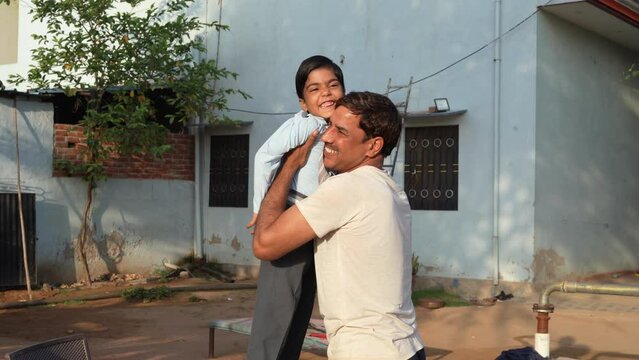 Dad hugging his little daughter in the park. Father and daughter outdoors smiling face to face