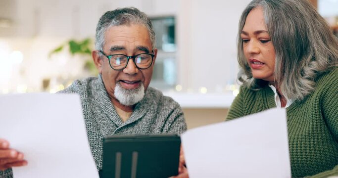 Senior couple, financial and planning with taxes and documents for budget at home. Paperwork, communication and investment management of a man and woman together talking about pension plan in house