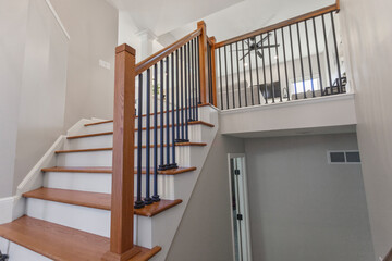 Wooden staircase with wrought iron black spindles 