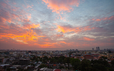 .The colorful sky over Bangkok city center in the evening..amazing red sky at sunset..Temples and buildings in Bangkok background..