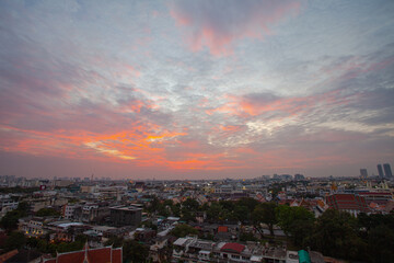 .The colorful sky over Bangkok city center in the evening..amazing red sky at sunset..Temples and buildings in Bangkok background..