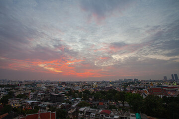 .The colorful sky over Bangkok city center in the evening..amazing red sky at sunset..Temples and buildings in Bangkok background..