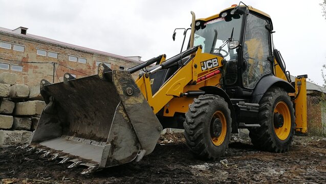 BIYSK, Russia - CIRCA, JULY, 2022: JCB wheeled tractor excavator.  Heavy machinery working on street.