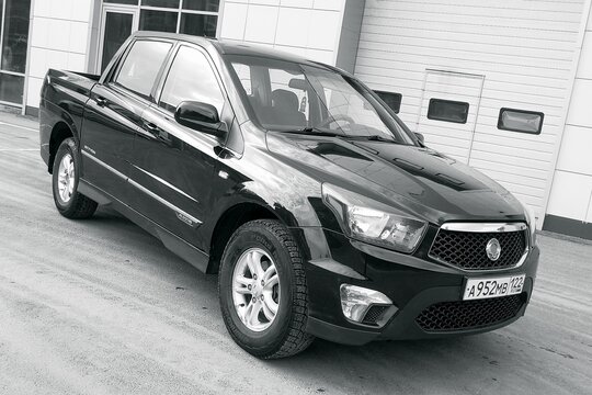 BIYSK, Russia -13.05.2022: SsangYong Actyon Sports 2012 pickup, parked on the city street winter street. Black and white photography.