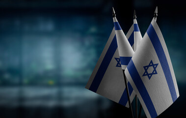 Small flags of the Israel on an abstract blurry background