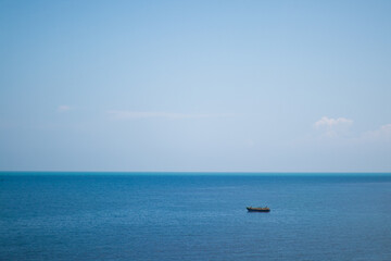 Fototapeta na wymiar One Small boat in the blue sea