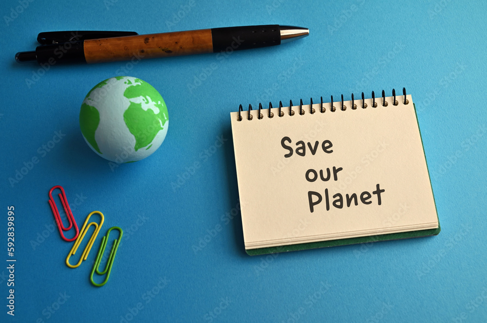 Poster there is a notebook with the word save our planet. it is eye-catching image.