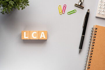 There is wood cube with the word LCA.It is an abbreviation for Life Cycle Assessment as eye-catching image.