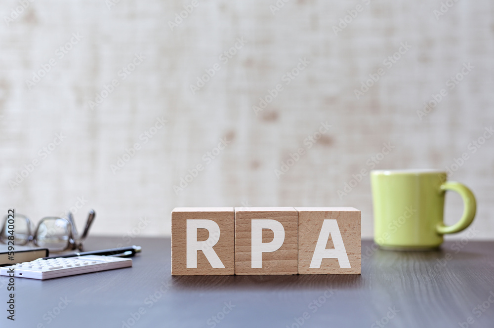 Poster there is wood cube with the word rpa. it is an acronym for robotic process automation an eye-catchin