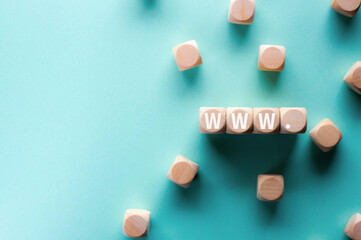 There is wood cube with the word WWW.It is an abbreviation for World Wide Web as eye-catching image.