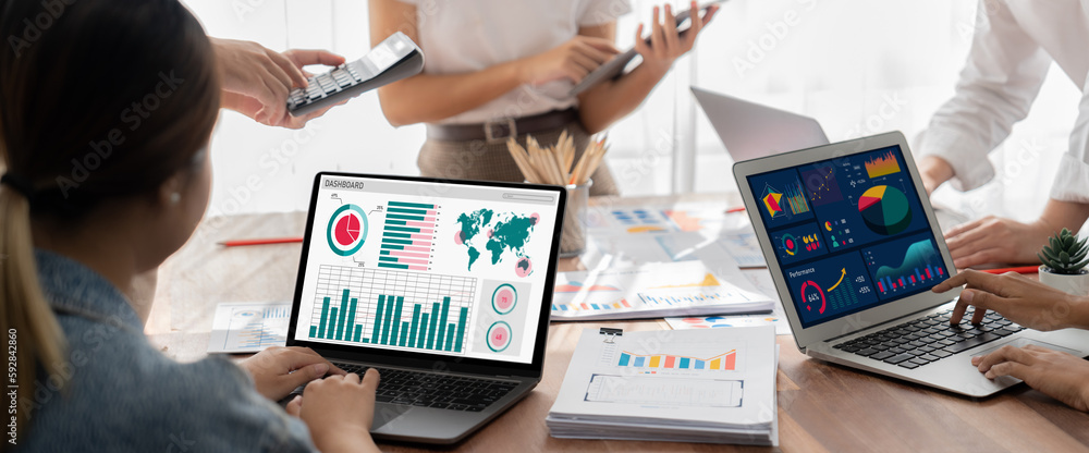 Leinwandbilder Panorama shot analyst team utilizing BI Fintech to analyze financial report with laptop. Businesspeople analyzing BI power dashboard displayed on laptop screen for business insight. Scrutinize