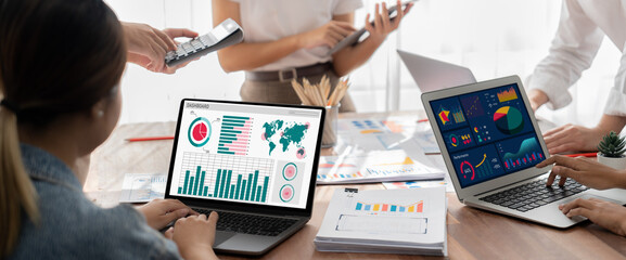 Panorama shot analyst team utilizing BI Fintech to analyze financial report with laptop....
