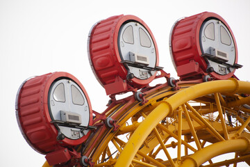 Ferris wheel cabins close up.Color cabins of a ferris wheel against the sky. Osaka, Japan.	
