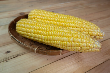 peeled yellow corn on a wooden table