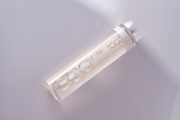 Pack of transparent lip gloss with brush and bubbles.