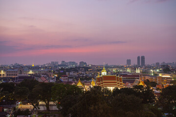 Fototapeta premium The colorful sky over Bangkok city center in the evening. amazing red sky at sunset. Temples and buildings in Bangkok background.