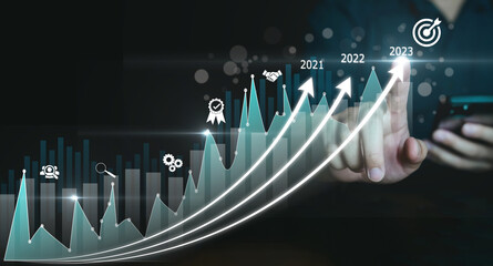 Businessman planning and business growth on desk with virtual screen. Calculate income and profit on investments and an increase in the indicators of positive growth.