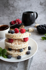 Rice cakes with berries and chocolate. Deliciously. A snack On a gray background