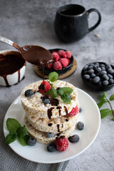 Rice cakes with berries and chocolate. Deliciously. A snack On a gray background