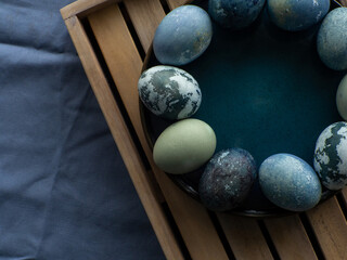 Blue painted easter eggs. Dyed Easter eggs with marble stone effect blue color on wooden planked background. Easter background. Copy space, Ester holiday postcard concept.