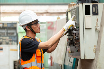 Industrial man man engineer wear uniform and helmet are checking system machine at factory. manager technician manufacturing. Workers industrial factory.