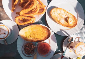 traditional spanish breakfast- churros and bread toast in a restaurant