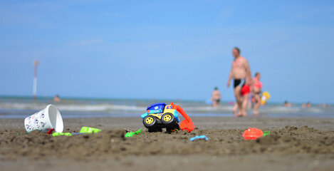 Fototapeta premium children's games on the sand in front of the sea