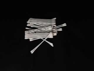 Several white cotton swabs isolated on black background