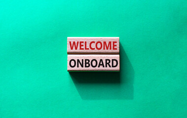Welcome onboard symbol. Concept words Welcome onboard on wooden blocks. Beautiful green background. Business and Welcome onboard concept. Copy space.