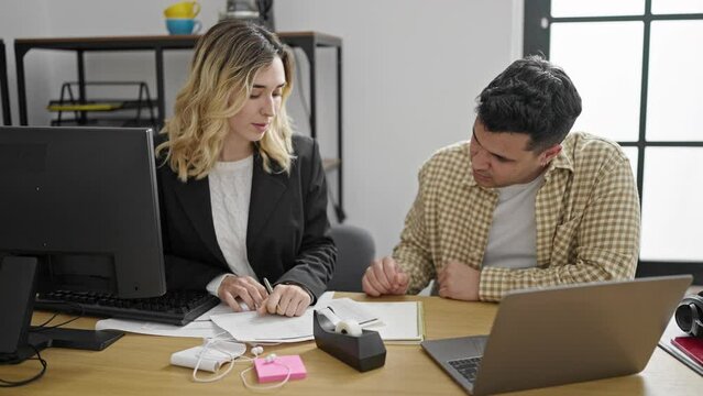 Man and woman business workers shake hands working at office