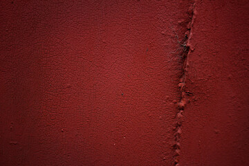 Red cracked paint on a metal door. Background, texture.