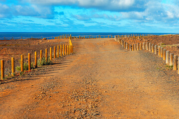Logs fenced walk path . Walking at ocean coast  