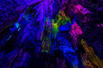 Illuminated natural underground rock formations inside St. Michaels cave in Gibraltar, UK