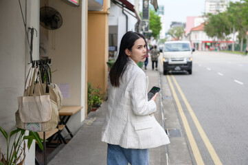 A young businesswoman is working in modern city downtown of Singapore