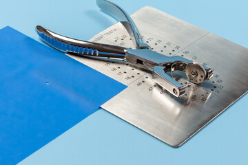 Dental hole punch, the rubber dam and the metal plate