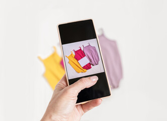 Secon hand, donate concept. Take a photo on phone of used baby clothes. Selling online of used....