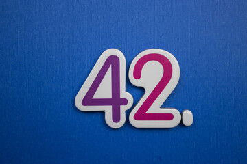 42. number of. Placed on a blue background, photographed from above.