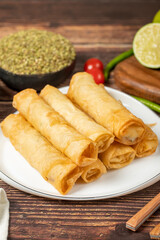 Cigarette pastry. Cheese pie on wood floor. Fried cheese rolls with phyllo. Local name sigara boregi. Close up
