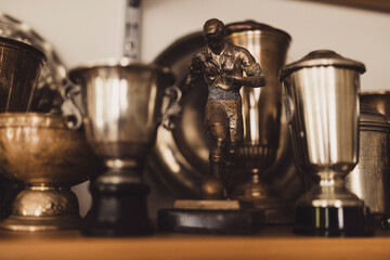 Soccer trophies on a shelf.  