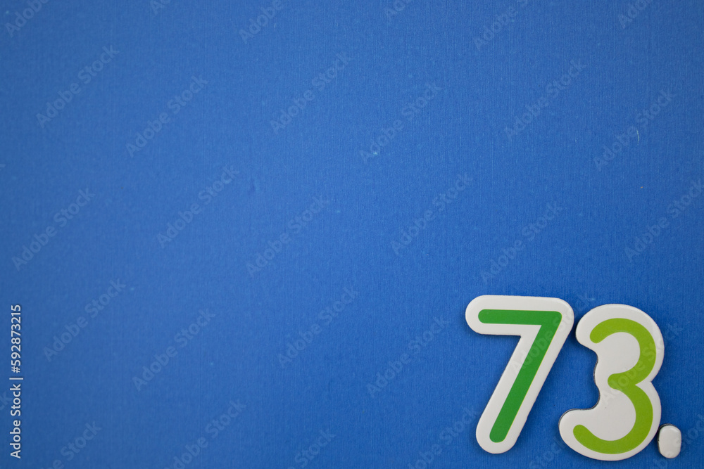 Wall mural 73. number of. placed on the edge of the blue background, photographed from above.