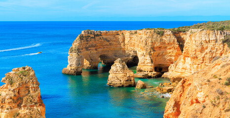 Fototapeta na wymiar Aerial view of majestic rock formation, coast of the Algarve- Tourism, travel, vacation in Europe (natural cave or arch on praia da marinha)