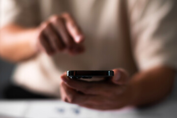 Fototapeta premium Close up of man hand pointing on smart phone. technology concept