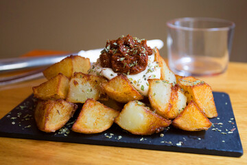 Papas bravas, are a typical preparation of bars in Spain consisting of potatoes cut into large cubes, fried in olive oil and seasoned with salsa brava, which is a spicy sauce.