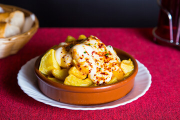 Papas bravas, are a typical preparation of bars in Spain consisting of potatoes cut into large cubes, fried in olive oil and seasoned with salsa brava, which is a spicy sauce.